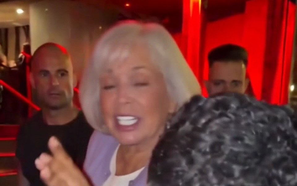 Grandmother with a white bob and lavender cardigan in the rapper's spot