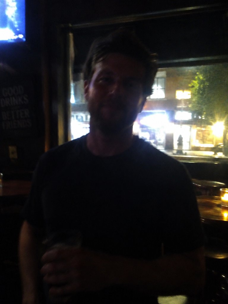 Underexposed, backlit and blurred snapshot of a person